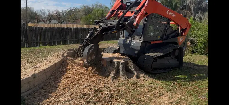 A tracked stump grinder working a big stump down